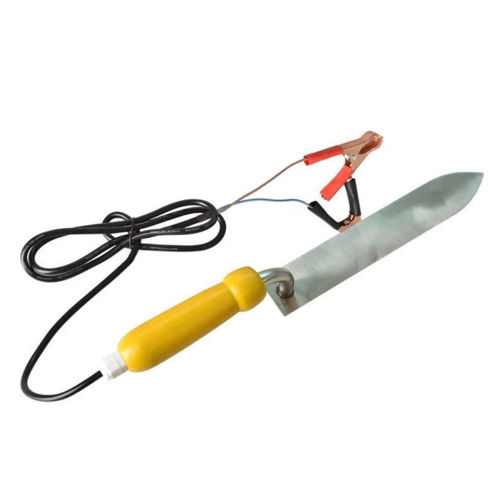 Side view of 12V electric uncapping knife showing stainless blade, insulated yellow handle, and copper alligator clips for mobile apiary use — BuzzBeeEquip.